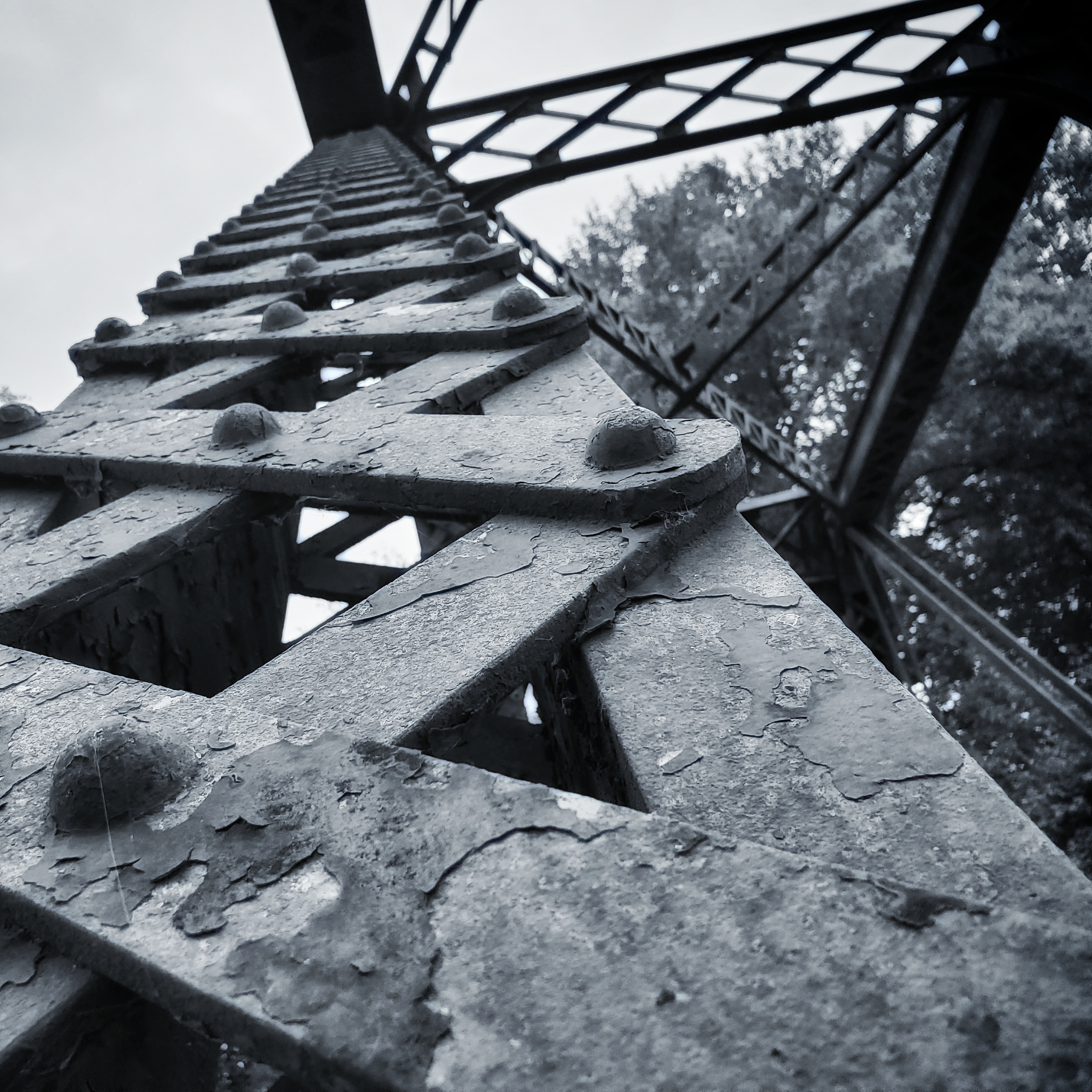 black and white photograph of railroad bridge close up